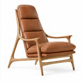Elegant brown armchair with high backrest from Architrave and Abacus, showcasing plush upholstery and sturdy wooden legs.