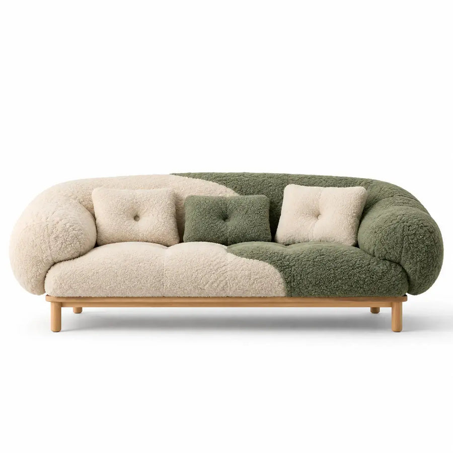 Beige and green curved sofa by architraveandabacus with smooth, rounded lines and plush upholstery in a stylish living room setting.